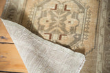 Hand-knotted woven foundation and geometric patterned pile of a vintage Oushak rug.