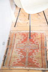 Vintage Oushak rug's upper section with fringe, rectilinear arrow medallion, and cinnabar field.
