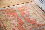 Detailed pile texture and curvilinear design of the cinnabar vintage Oushak rug.