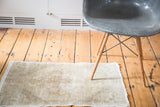 Distressed Oushak rug mat, showing textured pile in neutral beige, ivory, platinum.