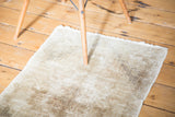 Distressed Oushak rug mat featuring faded texture in neutral beige and ivory tones.