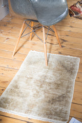 Hand-knotted distressed Oushak rug showcasing varied neutral beige and ivory texture.