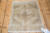Decorative distressed texture and faded neutral tones of a vintage Oushak rug.