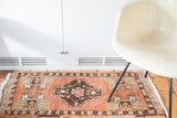 Vintage Oushak rug mat, cinnabar red field with geometric motifs and dark medallion.