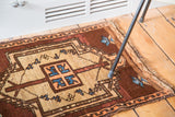Vintage Oushak rug featuring tribal arrows, stemming branches, aqua blue, copper, tangerine.