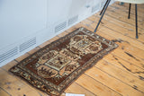 Hand-knotted vintage Oushak rug corner, showing geometric patterns in earthy brown and beige.
