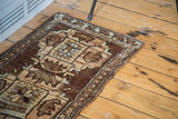 Upper edge of a Vintage Oushak rug, showing wooded tone geometric and stylized patterns.