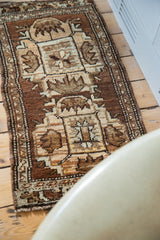 Hand-knotted corner detail of a vintage Oushak rug mat with wooded tones.