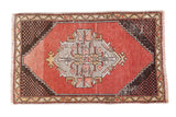 Distressed vintage Oushak rug mat, abrashed red field, grey diamond medallion, checkered spandrels.