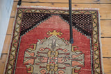Distressed Oushak rug medallion with geometric grey, blush, and saffron details.