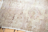 Distressed vintage Oushak rug texture, showing areas of low pile and subtle mauve.