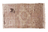 Distressed vintage Turkish Oushak rug mat, faded mauve field, abstract tree design.