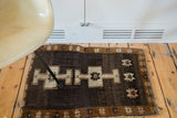 Vintage Oushak rug, deep chocolate field, double medallion, bronze star border.