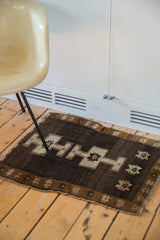 Geometric stars and crossed medallion on a chocolate field with bronze Oushak border.