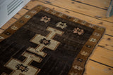 Traditional Turkish Oushak rug, chocolate field, bronze star border, geometric motif detail.