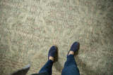 Soft green and ivory distressed Turkish Oushak rug, faded floral patterns.