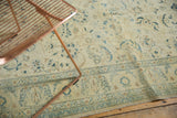 Distressed floral patterns on saffron yellow field with celadon and beige border.