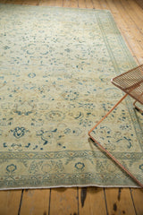 Distressed vintage Turkish Sivas rug corner, faded saffron field, celadon border, fringe.