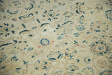 Faded saffron yellow field with distressed floral patterns in navy and celadon green.