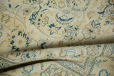 Textured fold of the distressed carpet highlighting faded saffron yellow and blue floral motifs.