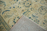Faded saffron yellow Sivas carpet with distressed floral design and visible hand-knotted foundation.