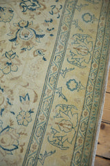 Distressed pile and muted celadon floral motifs on the saffron Sivas carpet.