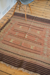 Vintage Turkish Jijim rug showing horizontal faded cranberry and charcoal stripes with geometric panels.