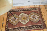 Geometric stepped medallion with diamond outlines, saffron yellow, and wave design on vintage Kilim.