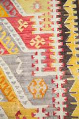 Hand-woven vintage Kilim with stepped medallions and hook designs in red, gold, and grey.