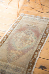 Soft texture and faded celadon, mauve, ivory hues on a distressed Oushak rug.