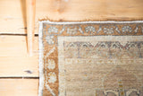 Distressed hand knotted Oushak rug border with bronze, beige, and dusty blue floral motifs.