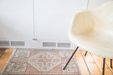 Vintage Oushak rug mat with blush field, stepped grey diamond motif, and barber pole border.