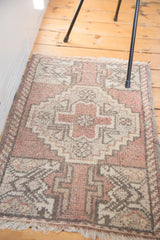 Vintage Oushak rug's blush stepped medallion, germinating tree, and barber pole border.