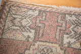 Hand-knotted Oushak rug pile texture in blush pink, charcoal, and cream hues.