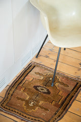 Vintage Oushak rug's bronze and dusty rose abrash, germinating plant motifs, and borders.