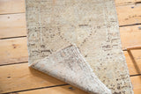 Hand knotted backing and fringe of the vintage Oushak rug with muted tones.
