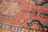 Textured vintage Oushak rug pile with tangerine orange, charcoal, and silver grey hook motifs.