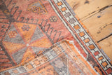 Vintage Oushak rug with tangerine, burnt orange, grey geometric hook motifs on pile and woven foundation.