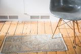 Hand-knotted distressed Oushak rug mat with faded sandalwood and grey geometric patterns.