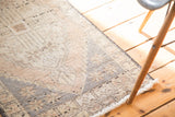 Distressed pile texture and fringe of vintage Oushak rug, faded peach and ivory.