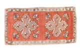 Distressed Oushak rug mat, faded brick red, featuring double quatrefoil medallions.