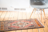 Vintage Oushak rug mat, expressive curvilinear medallion, faded red, orange, and brown tones.