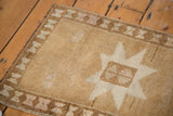 Hand-knotted Vintage Oushak rug corner, ivory star, bronze field, and geometric border.
