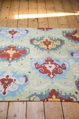 Ikat-inspired pattern detail of a hand-woven Chainstitch rug with cherry red and saffron yellow.