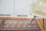 Vintage Oushak rug featuring repeating floral guls on an unusual mauve field with abrash.