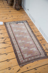 Vintage Oushak rug corner, showing unusual mauve field and intricate faded terra cotta border.