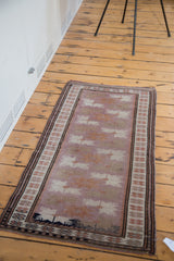 Intricate border details of a vintage Oushak rug, with charcoal blue pictorial elements.