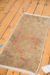 Subtle double medallion design in muted beige and terra cotta on vintage Oushak rug.