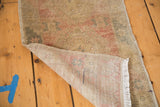 Hand-knotted Oushak rug's woven foundation, low pile texture, and delicate fringe.