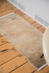 Subtle beige and muted terra cotta tones of a hand-knotted Oushak rug mat.
